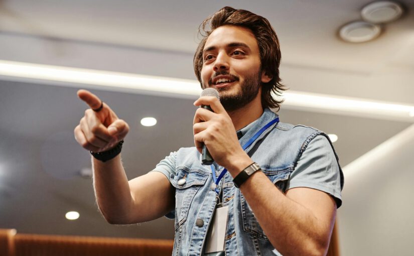 a young man talking with a microphone